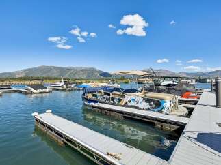 Experience lakeside living with this stunning property featuring a private dock and boat slips, perfect for water enthusiasts.