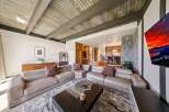 Experience modern living in this spacious living room featuring a large sectional sofa and a striking stone fireplace.