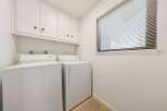 This laundry room features a stacked washer and dryer set, perfect for maximizing space.