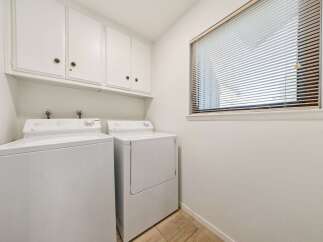 This laundry room features a stacked washer and dryer set, perfect for maximizing space.