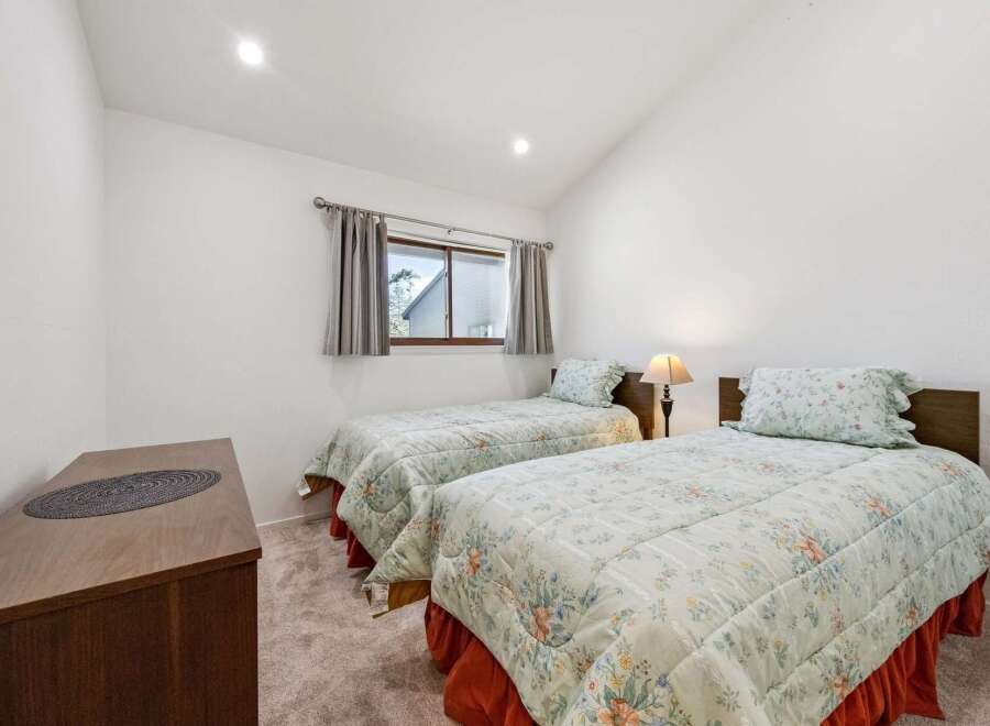 This charming bedroom features two comfortable twin beds, perfect for accommodating guests or family.