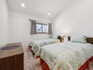 This charming bedroom features two comfortable twin beds, perfect for accommodating guests or family.