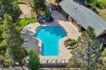 Enjoy a refreshing dip in this stunning geometric pool, surrounded by lush landscaping and ample lounge chairs for ultimate relaxation.