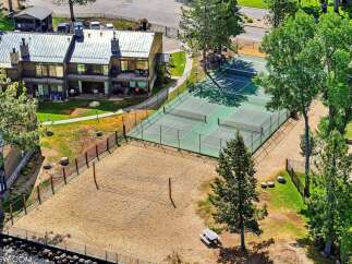 Experience resort-style living with this stunning property featuring a private volleyball court and multiple tennis courts perfect for recreation and exercise.