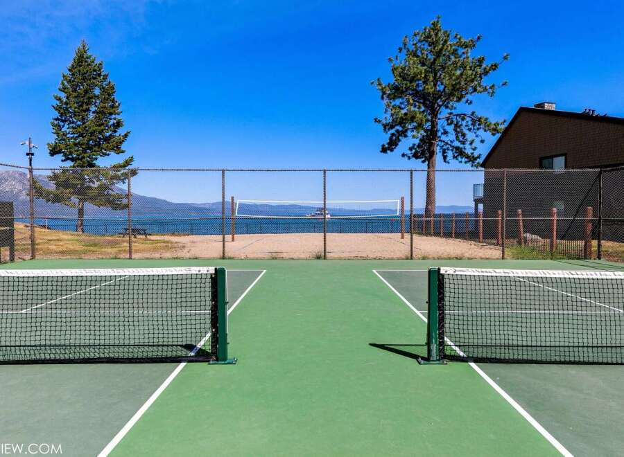 Enjoy outdoor recreation with this property's dual-purpose sports courts, featuring both tennis and pickleball lines.