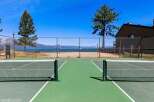 Enjoy outdoor recreation with this property's dual-purpose sports courts, featuring both tennis and pickleball lines.