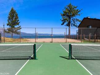 Enjoy outdoor recreation with this property's dual-purpose sports courts, featuring both tennis and pickleball lines.