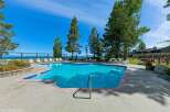 Enjoy a refreshing dip in this stunning swimming pool, complete with a sleek metal handrail for easy access.