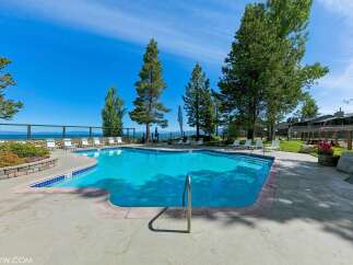 Enjoy a refreshing dip in this stunning swimming pool, complete with a sleek metal handrail for easy access.