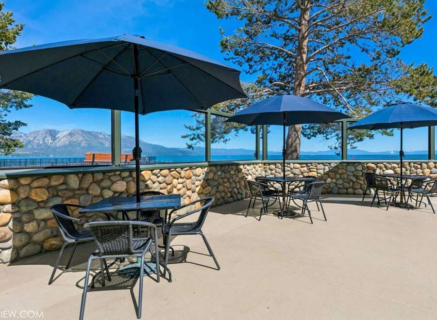 Enjoy breathtaking lake and mountain views from this outdoor seating area, perfect for al fresco dining or relaxing with a drink.
