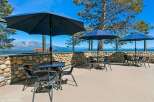 Enjoy breathtaking lake and mountain views from this outdoor seating area, perfect for al fresco dining or relaxing with a drink.