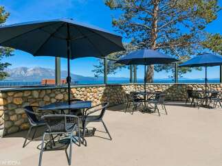 Enjoy breathtaking lake and mountain views from this outdoor seating area, perfect for al fresco dining or relaxing with a drink.