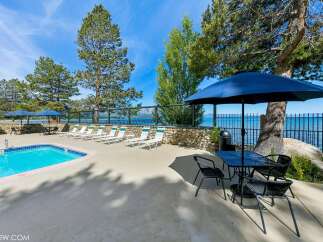 Enjoy a refreshing dip in the sparkling blue pool, surrounded by comfortable lounge chairs perfect for soaking up the sun.