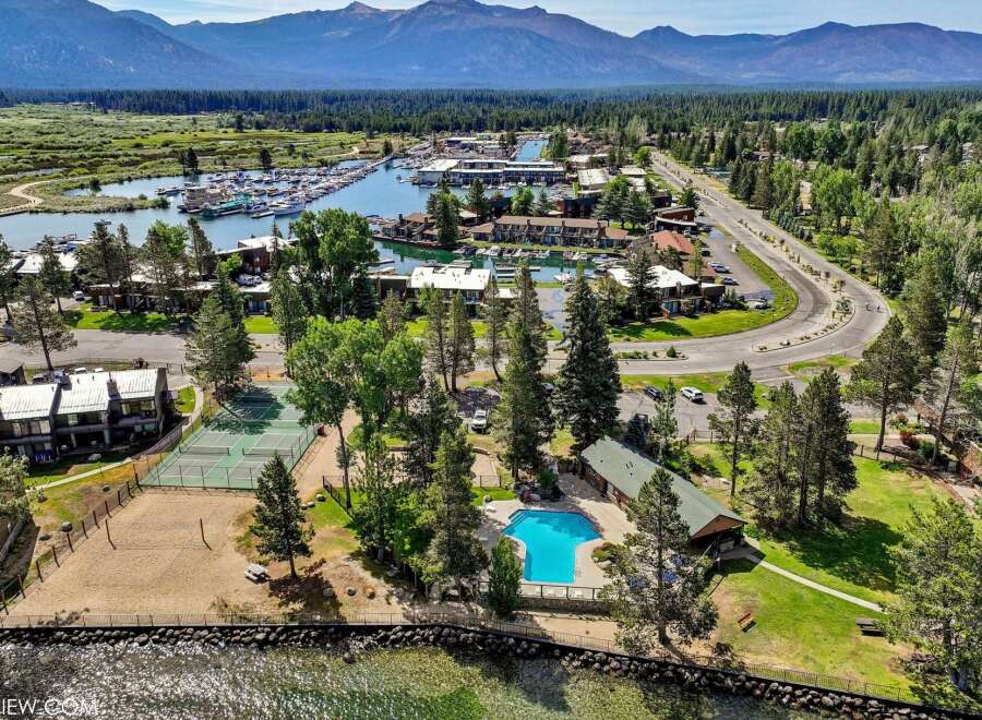 Experience lakeside living with this stunning aerial view showcasing a vibrant community.