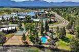 Experience lakeside living with this stunning aerial view showcasing a vibrant community.