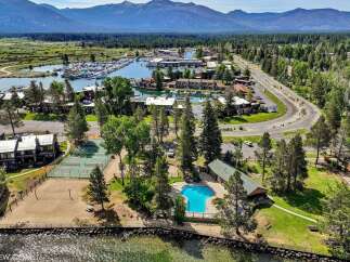 Experience lakeside living with this stunning aerial view showcasing a vibrant community.