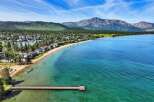 Experience luxury living with this stunning waterfront property offering direct access to a pristine sandy beach and crystal-clear turquoise waters.