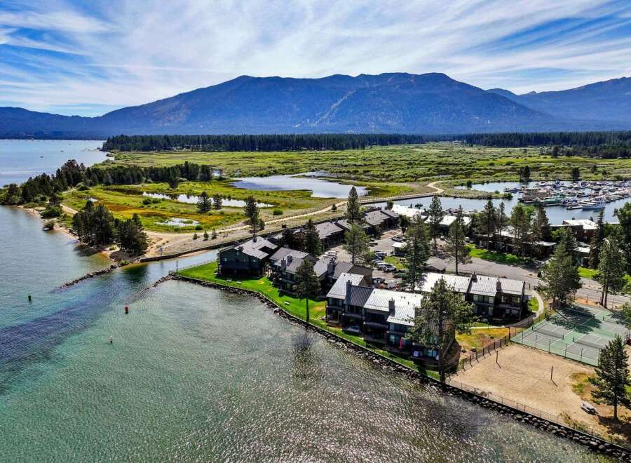 Experience lakeside living at its finest with this stunning aerial view of a waterfront property.