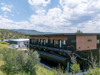Discover modern living in this multi-level property, featuring a sleek design with wood and dark metal accents.