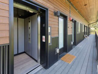 Experience convenient living with this modern exterior featuring an accessible elevator and multiple unit entrances.
