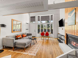 Experience cozy living in this inviting space featuring a modern sectional sofa adorned with colorful accent pillows.