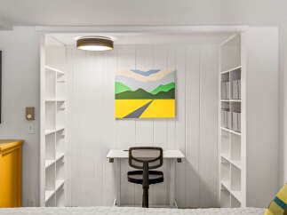 Discover this charming alcove featuring a built-in desk and shelving, perfect for a home office or study nook.