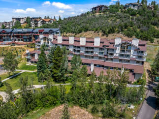 Discover luxury mountain living in this stunning multi-level condominium complex, nestled amidst lush greenery and scenic slopes.