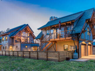 Experience modern mountain living in this stunning architectural gem, featuring a unique blend of rustic wood and sleek metal finishes.