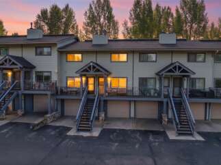 Experience comfortable living in this multi-unit townhome complex, featuring private garages and upper-level decks perfect for enjoying the twilight sky.