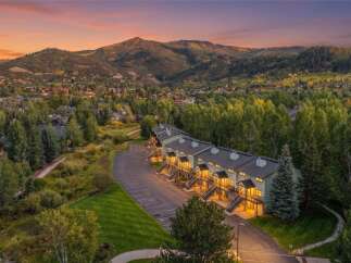 Experience luxury mountain living in this stunning property, perfectly situated amidst a vibrant autumn landscape.