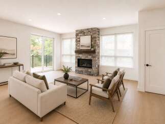 Experience modern living in this beautifully appointed living room, featuring a striking stone fireplace as the focal point.