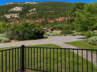 Nestled against a backdrop of majestic red rock cliffs and lush green mountains, this property offers a serene escape.