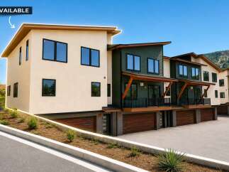 Discover modern living in this stunning townhome, featuring a sleek beige exterior and a contrasting dark green facade.