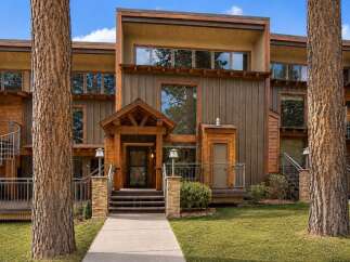 Experience modern mountain living in this stunning property featuring a striking architectural design with natural wood siding and expansive windows.