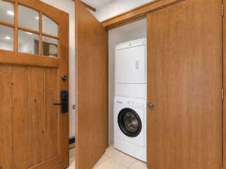 Step into this charming property featuring a beautiful wooden front door with a glass paneled top and a modern digital lock for added security.
