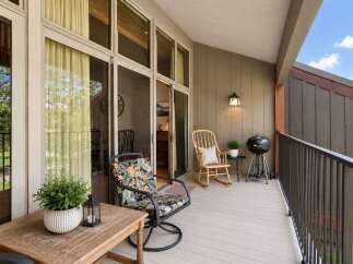 Enjoy outdoor living on this spacious balcony, perfect for entertaining or relaxing.