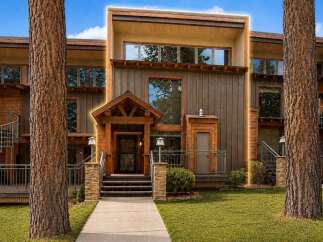 Experience modern mountain living in this stunning property featuring a striking architectural design with natural wood siding and expansive windows.