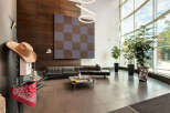 Step into a modern and inviting lobby featuring sleek black leather sofas and a stylish checkered accent wall.