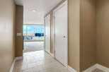 Step into this inviting hallway featuring a neutral color palette and sleek tile flooring.