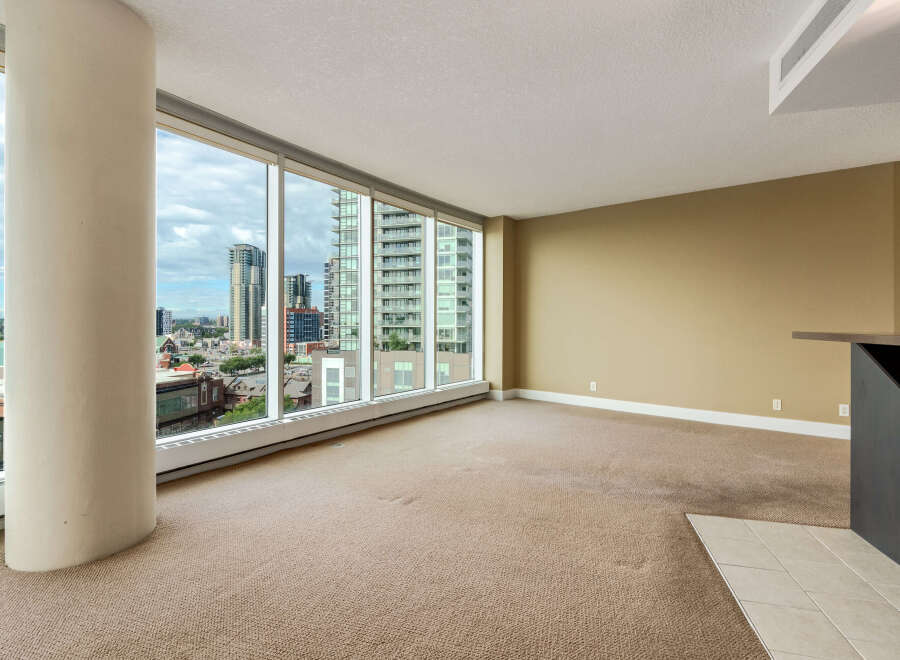 Experience breathtaking city views from this spacious living area, featuring expansive floor-to-ceiling windows that flood the room with natural light.