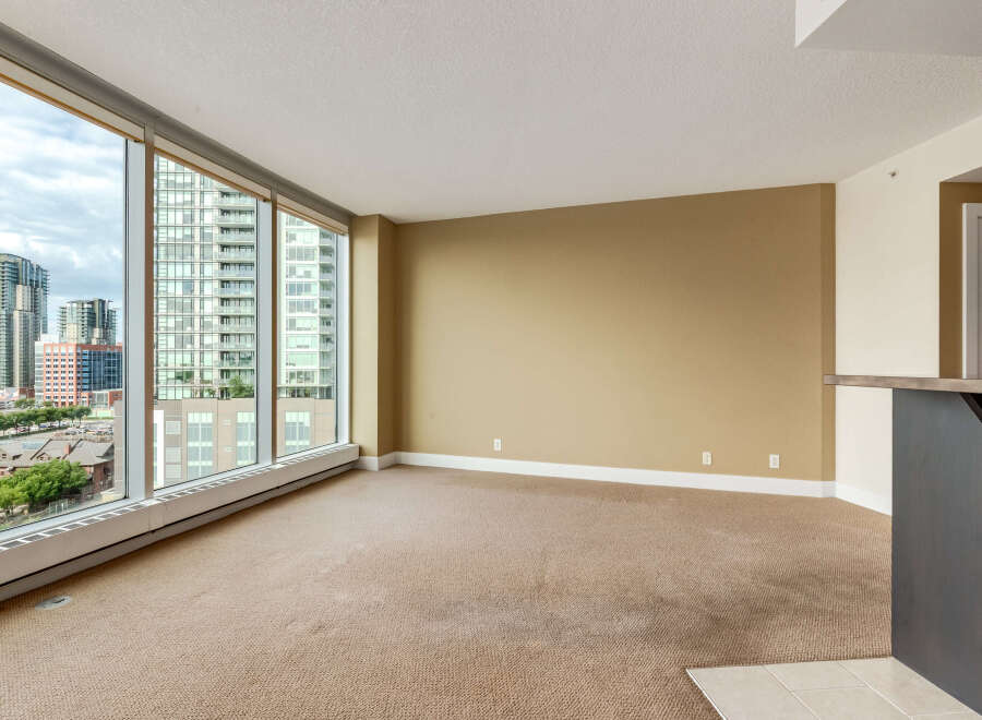 Experience breathtaking city views from this spacious living area, featuring expansive windows that flood the room with natural light.