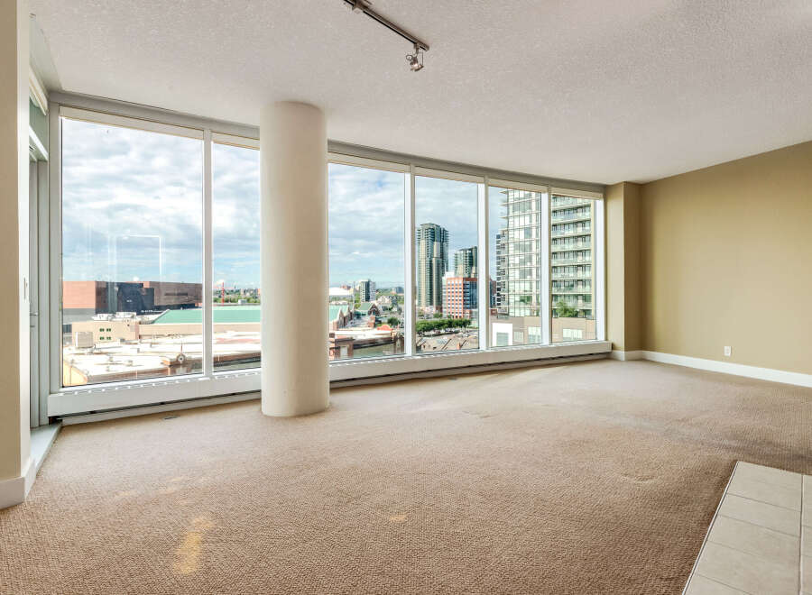 Experience breathtaking city and water views from this spacious condo living area.