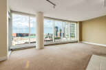 Experience breathtaking city and water views from this spacious condo living area.