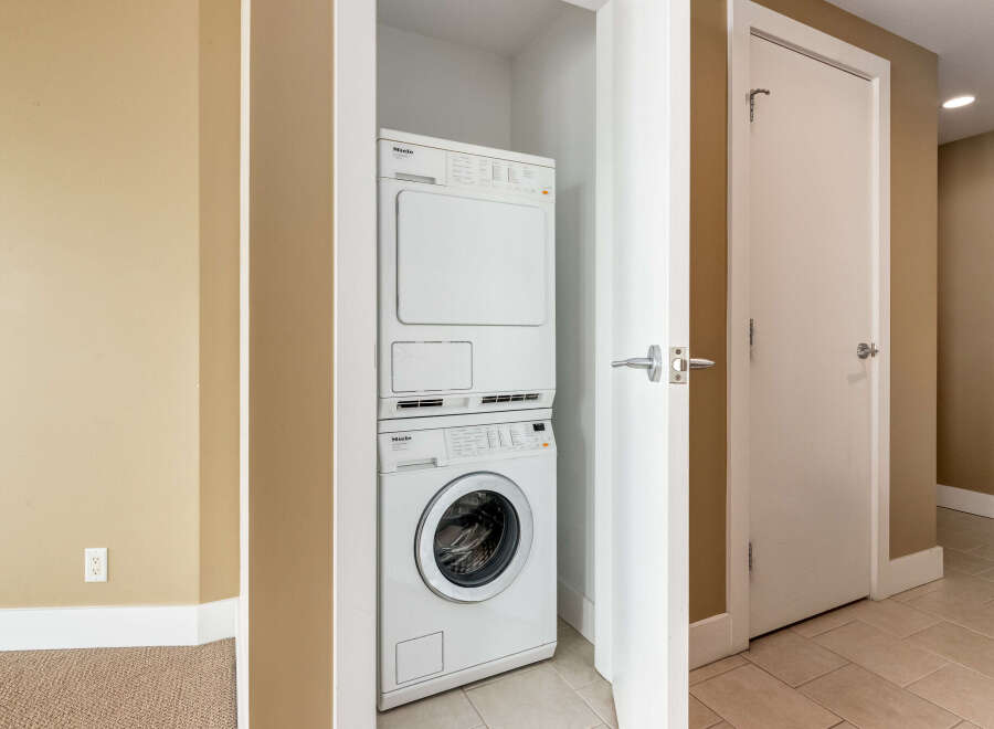 Discover convenience with this stacked Miele washer and dryer set, perfect for optimizing space in your laundry area.
