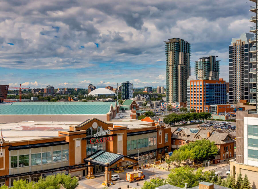 Experience the vibrant urban lifestyle with this stunning city view, featuring modern high-rise apartments and the iconic Cowboys Casino.