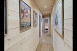 Step into this charming wooden hallway, adorned with vintage travel posters that evoke a sense of alpine adventure.