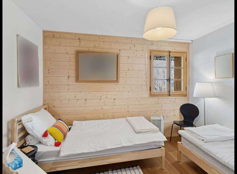 This charming bedroom features two twin beds with crisp white linens, perfect for accommodating guests or family.