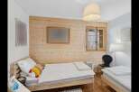 This charming bedroom features two twin beds with crisp white linens, perfect for accommodating guests or family.
