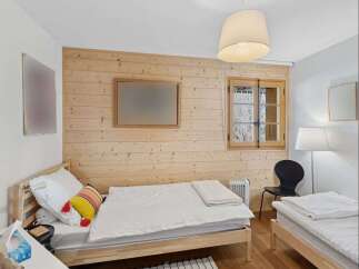 This charming bedroom features two twin beds with crisp white linens, perfect for accommodating guests or family.