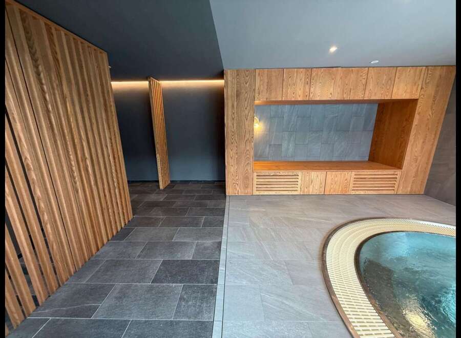 Experience tranquility in this modern spa oasis, featuring a soothing pool and elegant wooden accents.